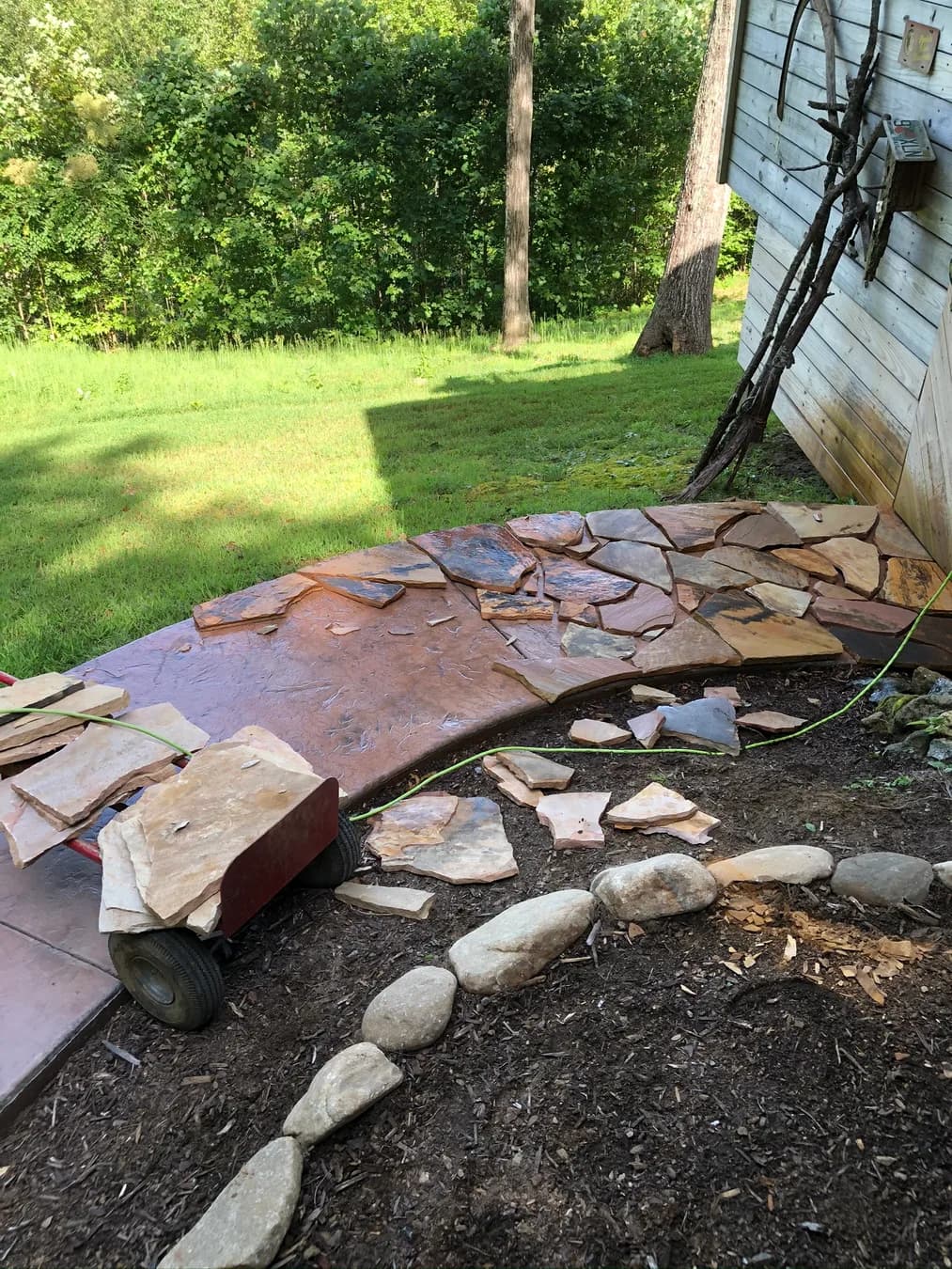 Mortared flagstone installation beginning along an existing curved walk, view 3