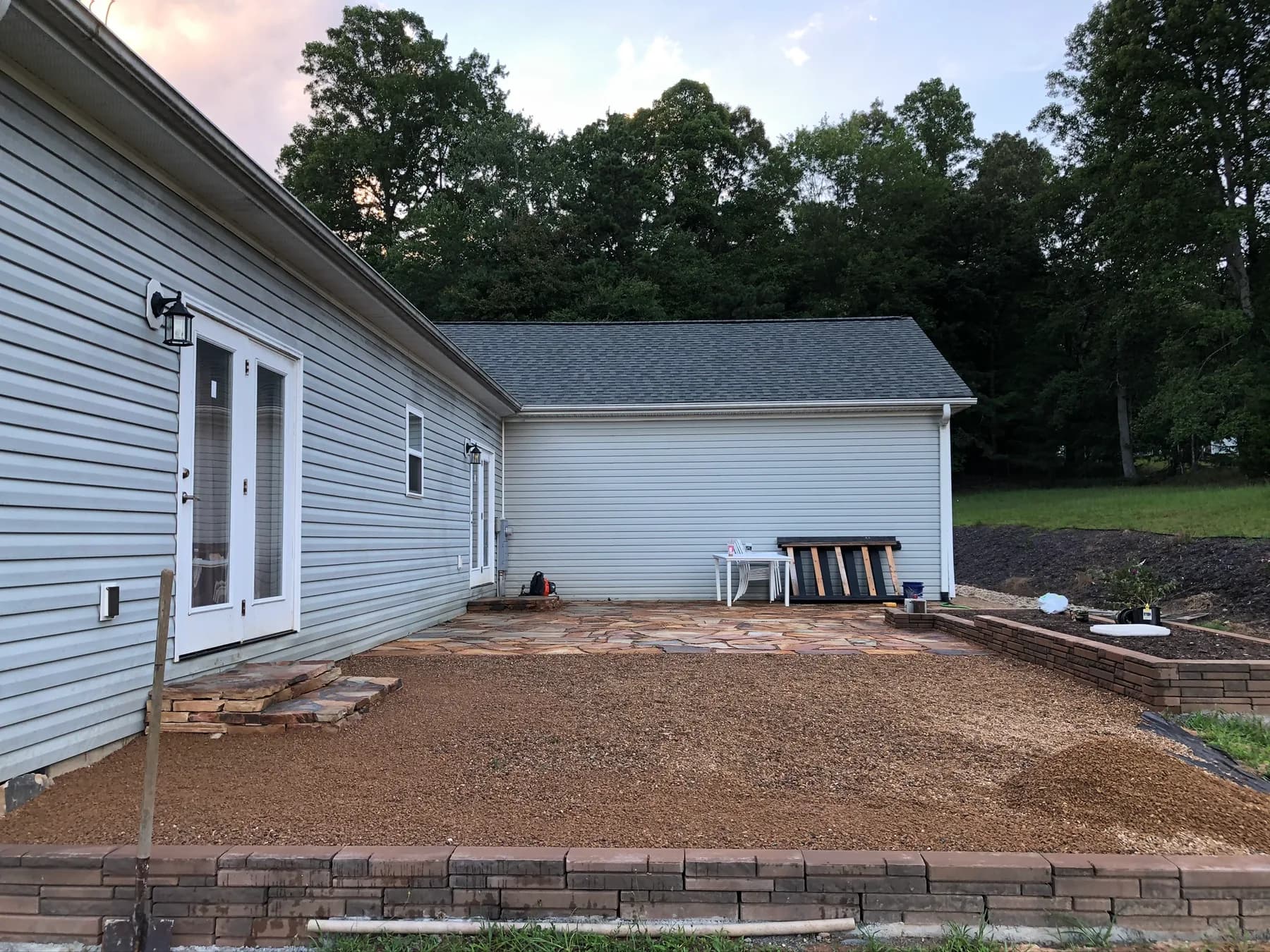 Finished natural stone patio and step transition with gravel surface tie-in, view 8