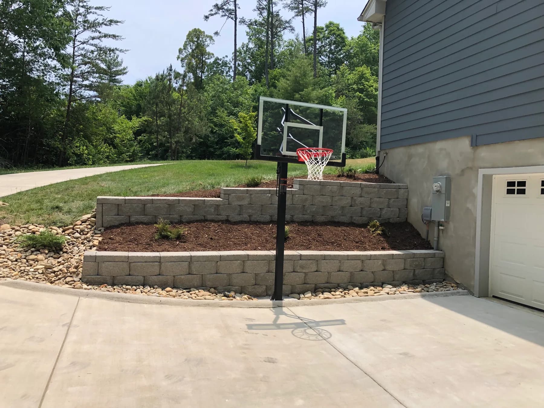 Masonry site wall work along a residential recreation edge, view 1