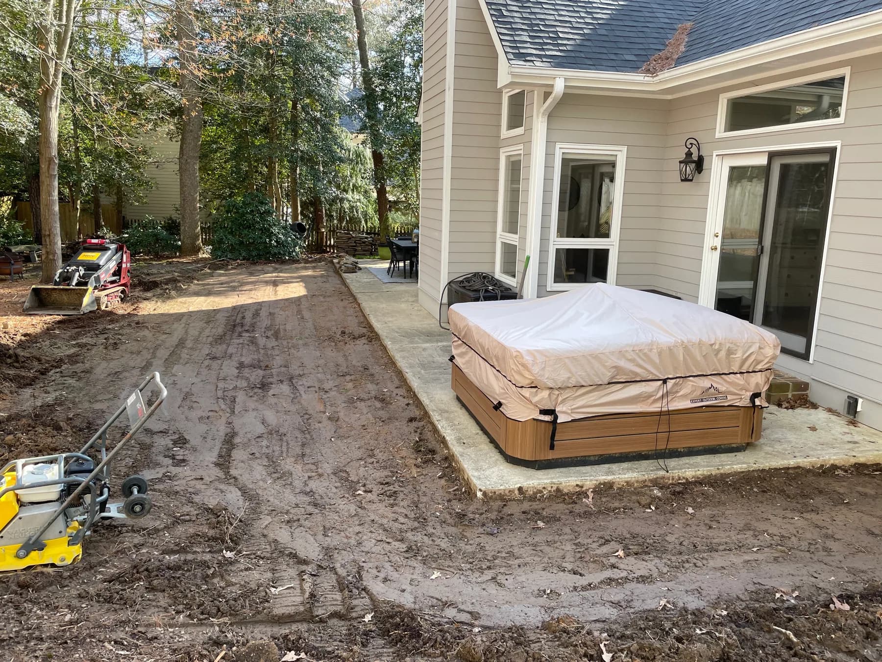 Woodland stone patio project with stone surfacing, border work, and outdoor seating area, view 1