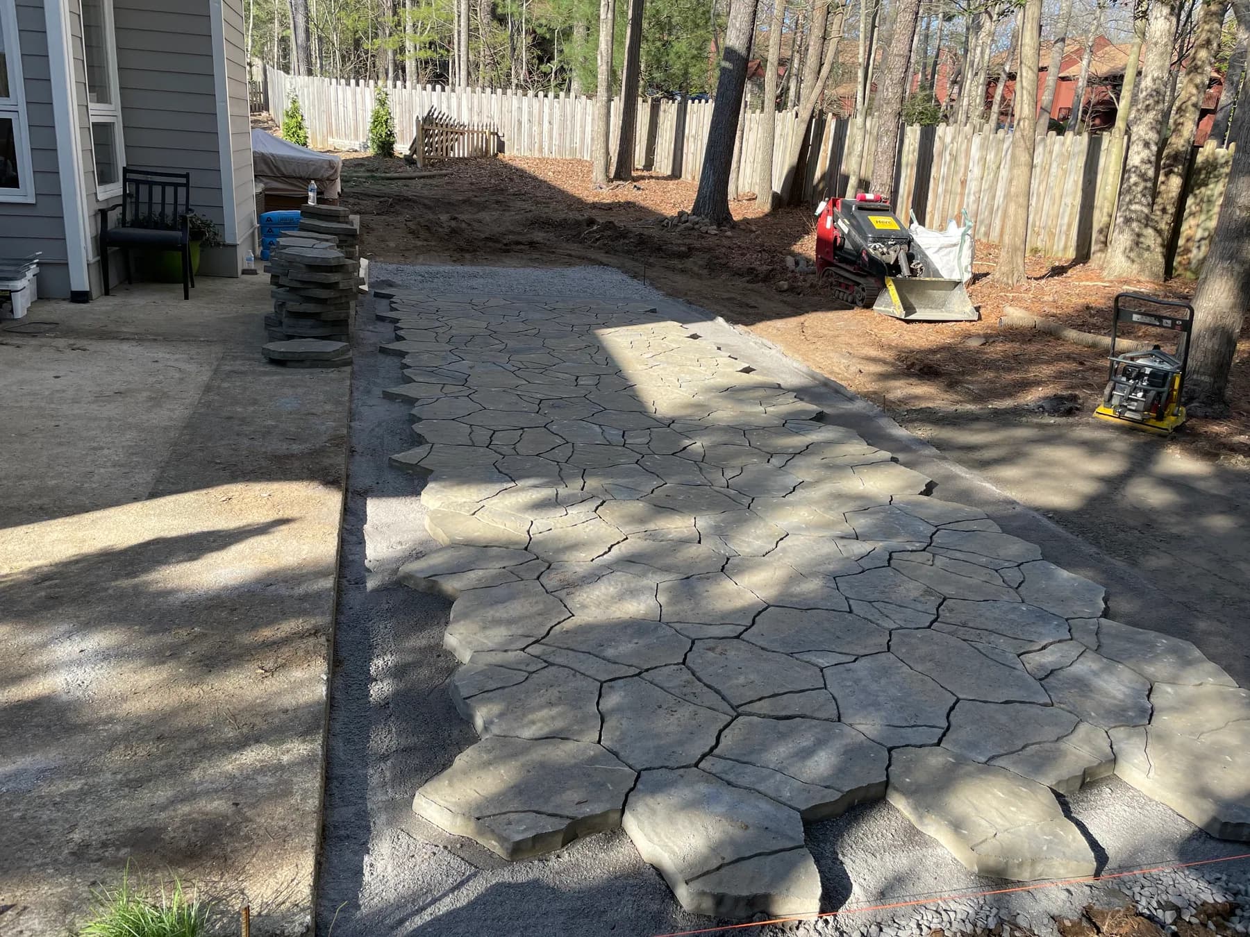 Woodland stone patio project with stone surfacing, border work, and outdoor seating area, view 5