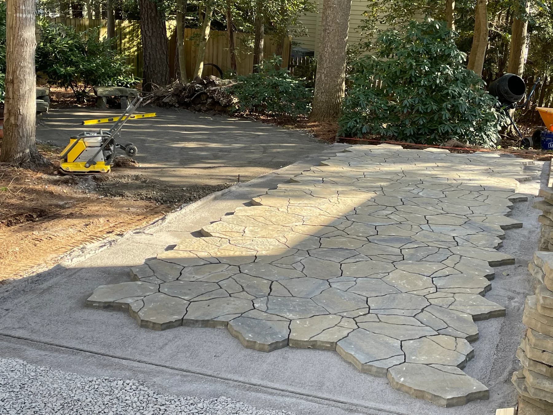Woodland stone patio project with stone surfacing, border work, and outdoor seating area, view 7
