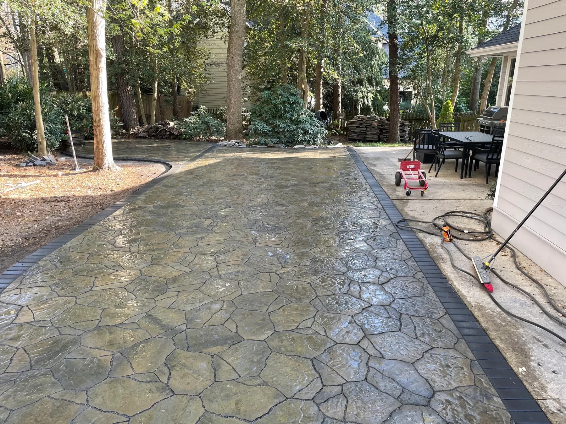 Woodland stone patio project with stone surfacing, border work, and outdoor seating area, view 14